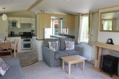 a living room with a couch and a table at Ben View in Taynuilt