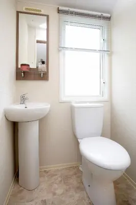 a bathroom with a toilet and a sink and a window at Loch View in Taynuilt