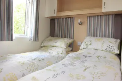 two beds sitting next to each other in a bedroom at Mountain View in Taynuilt