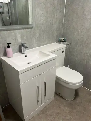 a bathroom with a white sink and a toilet at The Swan Inn in Stranraer