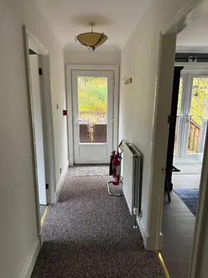 a hallway with a door leading to a room at Lochwood Guest House in Lochgoilhead