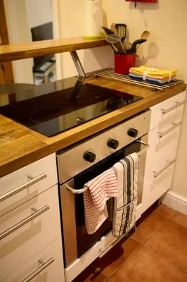 a kitchen with a stove with towels hanging from it at Central Stay on Main st- Harbour Views in Oban