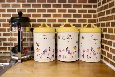 a group of three tumblers with flowers painted on them at Central Stay on Main st- Harbour Views in Oban