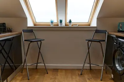 two stools in a kitchen with two windows at Stunning 2BR Loft Apt in Oban - Sea Views in Oban