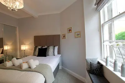 a bedroom with two beds and a window at JOIVY Unique Old Town Stay under Edinburgh Castle in Edinburgh