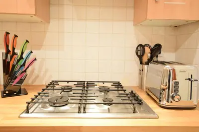 a stove top oven sitting on top of a kitchen counter at JOIVY Classic Apt with Castle Views in Old Town in Edinburgh