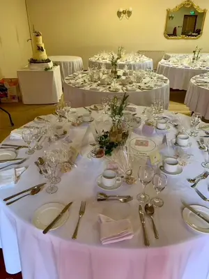 a table with white plates and silverware on it at Dunmar House Hotel - Bar & Restaurant in Alloa