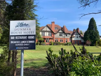 a sign in front of a house at Dunmar House Hotel - Bar & Restaurant in Alloa