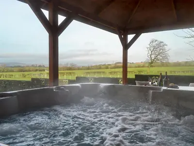 a bath tub filled with water in a patio at Hillview in Beith