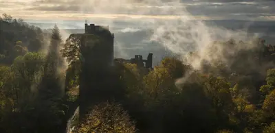 a castle in the middle of a forest with fog at Dollar Apartments-39 Bridge Street in Dollar