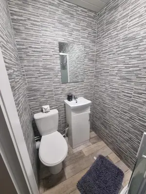 a bathroom with a white toilet and a sink at Windsor house in Stranraer