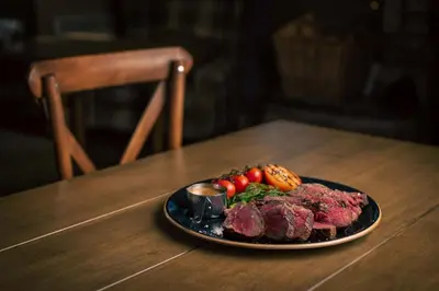 a plate of meat and vegetables on a table at The Murray Park Hotel in Crieff