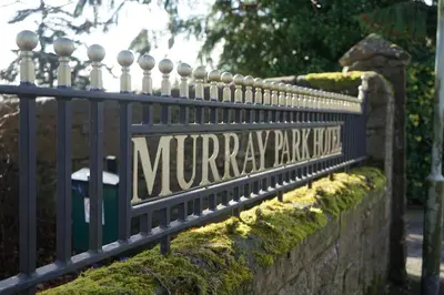a sign that reads murray parkride on a fence at The Murray Park Hotel in Crieff