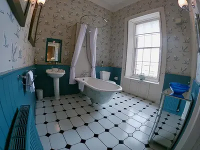a bathroom with a tub and a sink at Escape To Edinburgh @ Albyn Place in Edinburgh