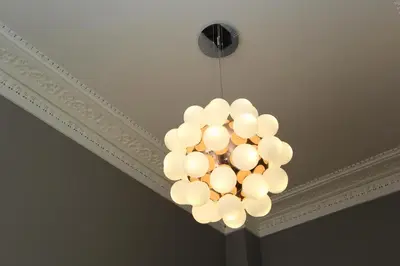 a chandelier hanging from a ceiling in a room at Escape To Edinburgh @ Albyn Place in Edinburgh