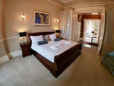 a bedroom with a large bed with two pillows at Escape To Edinburgh @ Albyn Place in Edinburgh