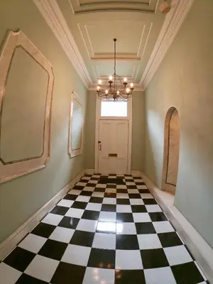 a hallway with a black and white checkered floor at Escape To Edinburgh @ Albyn Place in Edinburgh