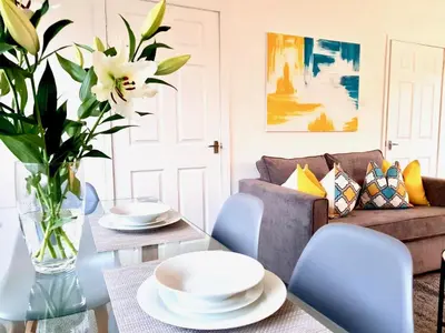 a living room with a table and chairs and a couch at South Calder House in Wishaw