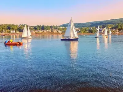 a group of small sailboats on a lake at Firwood Apartment in Kilmun