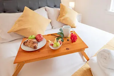 a table with a plate of food on a bed at Stirling Mercury Apartment - Scotland Holiday Let in Stirling