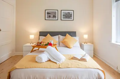 a bedroom with a bed with towels on it at Stirling Mercury Apartment - Scotland Holiday Let in Stirling