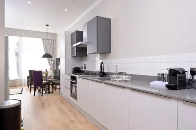 a kitchen with white walls and a counter top at Destiny Scotland Charlotte Square Apartments in Edinburgh