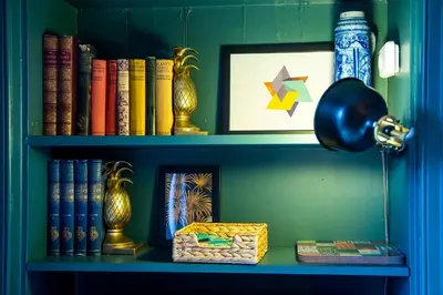 a book shelf filled with books and a lamp at GuestReady - Stylish 2BR in Heart of Tollcross in Edinburgh
