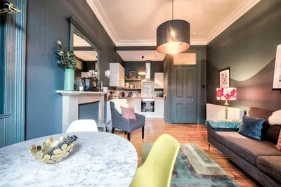 a living room with a table and a couch at GuestReady - Stylish 2BR in Heart of Tollcross in Edinburgh