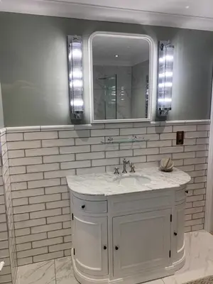 a white bathroom with a sink and a mirror at Stormfront Luxury Hideaway Glencoe Ballachulish Highlands Near Fortwilliam in Glencoe