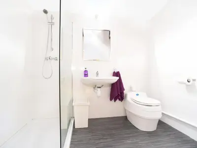 a white bathroom with a toilet and a sink at Carr's Hill Luxury Safari Tents in Denny