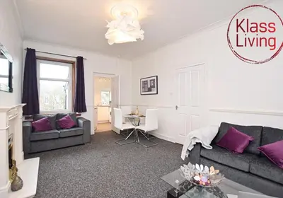 a living room with a couch and a table at Whifflet Apartment by Klass Living Coatbridge in Coatbridge
