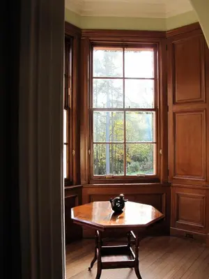 a table in a room with a window at Glencoe House in Glencoe