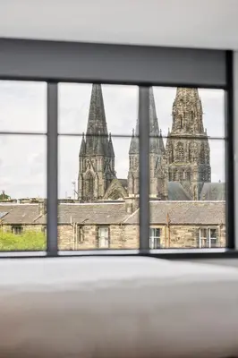 a view of a building through a window at Garner Hotel Edinburgh - Haymarket by IHG in Edinburgh