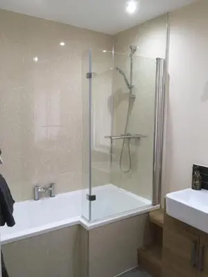 a bathroom with a shower with a glass door at 1 Balnakeil, Kirk Road in Oban