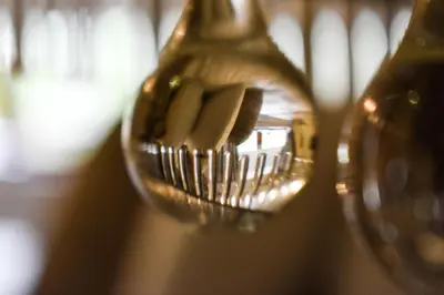 a close up of a wine glass with a bunch of wine bottles at Dalziel Park Hotel in Motherwell