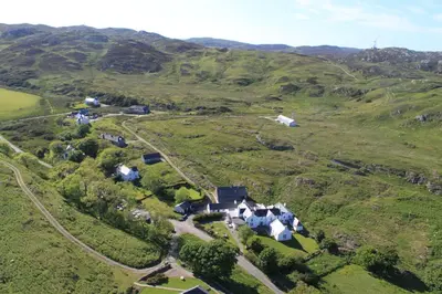 an aerial view of a village in the hills at The Colonsay Hotel in Isle of Colonsay