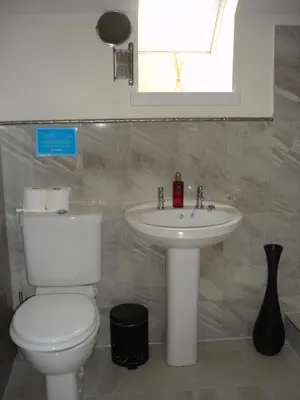 a bathroom with a toilet and a sink at Kilchurn Suites in Loch Awe