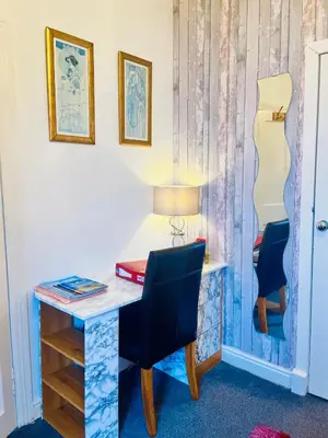 a desk with a chair and a desk with a lamp at Rowantreebank Bed and Breakfast in Arrochar
