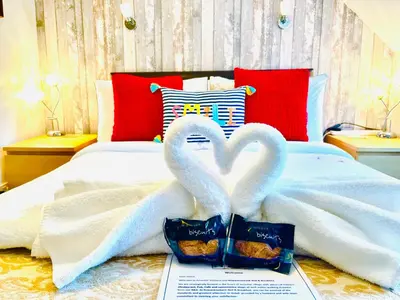 two swansrendered to look like hearts on a bed at Rowantreebank Bed and Breakfast in Arrochar