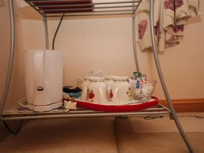 a metal shelf with three white cups on it at Shenavallie Farm in Benderloch