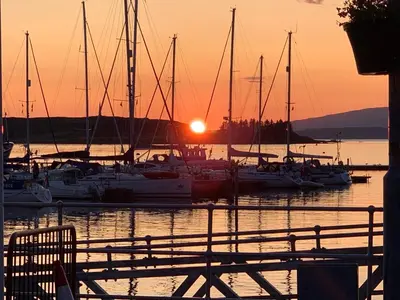 a group of boats docked in a marina at sunset at Altavona House in Oban
