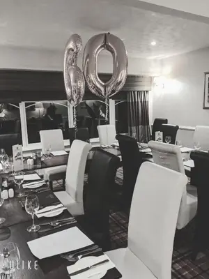 a dining room with a long table with silver balloons at Glazert Country House Hotel in Lennoxtown