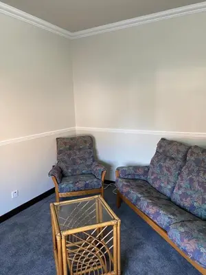 a living room with a couch and a chair at Welltrees Apartments 10 Dailly Road in Maybole