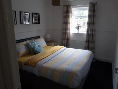 a bedroom with a bed and a window at Hardgate Gardens in Glasgow