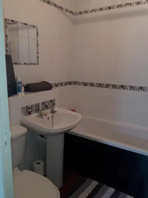 a bathroom with a sink and a toilet and a tub at Hardgate Gardens in Glasgow