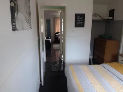 a bedroom with a bed and a door leading into a room at Hardgate Gardens in Glasgow