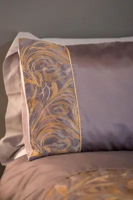 a pillow sitting on top of a bed at Cottage Apartment in Dunblane