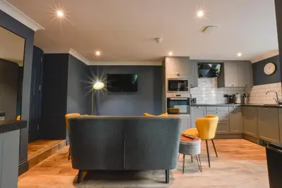 a living room with a couch and a kitchen at Raniven in Oban