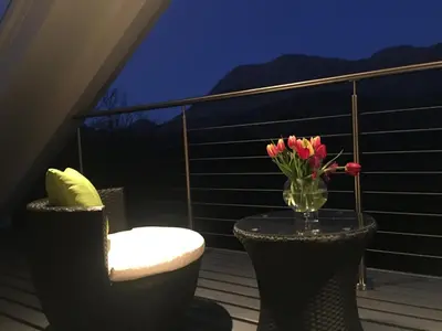 a balcony with a vase of flowers on a table at Invercreran Lodge Luxury Bed & Breakfast in Appin