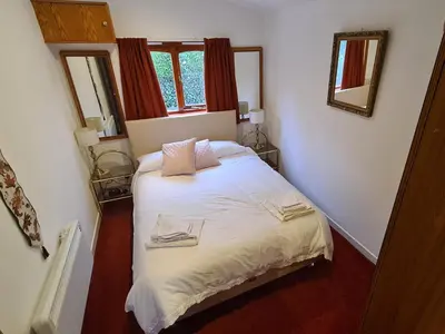 a bedroom with a bed with two towels on it at Hawthorn Self Catering Cottages in Benderloch
